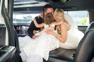 Bride, groom, and daughter hugging at wedding in Wollongong, New South Wales