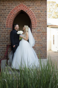 Bride and groom laughing after church wedding in Wollongong, New South Wales