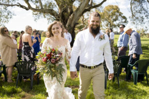 Jasmin and Cameron walking down aisle after wedding ceremony in Country New South Wales