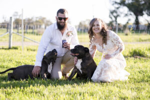 Jasmin and Cameron with dogs posing for wedding photographer in Country New South Wales
