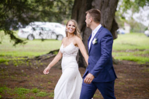 Bride and groom holding hand after wedding at Redcourt Homestead in Melbourne