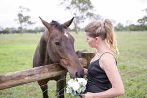 bridesmaid and horse posing for wedding photographer at Redcourt Homestead in Melbourne