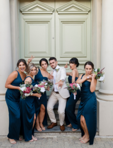 groom and bridesmaids posing for wedding photographer in Fremantle