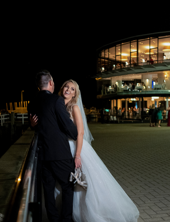 Bride and groom posing for wedding photographer in Wollongong