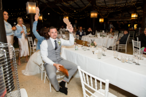 bride and groom playing shoe game during wedding reception