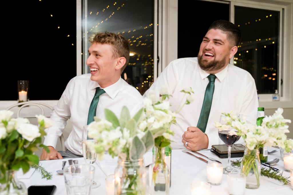 groomsmen laughing during wedding reception speeches at Sublime Point