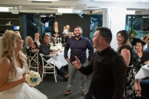 groom tossing garter at wedding reception in Sydney, Australia