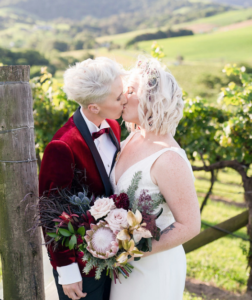 Bride and bride kissing at winery wedding in New South Wales