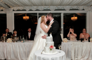 Deanna and Dean kissing at wedding reception captured by Emot Wedding Photography