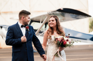 bride and groom laughing after wedding at Camden Airport