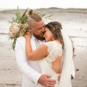 Bride and groom hugging on beach in Gerroa, New South Wales