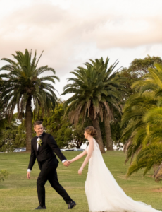Bride and groom walking at sunset after Cropley House wedding