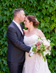 Groom kissing bride on head at wedding in Adelaide, South Australia