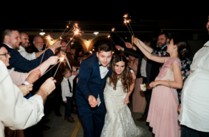 Bride and groom exiting reception under sparklers in Camden, New South Wales