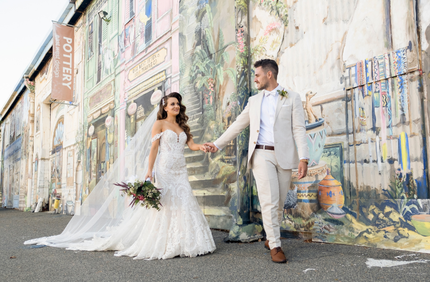 Bride and groom holding hand in front of East West Design in Fremantle Western Australia