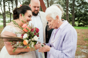 Photo of bride showing bouquet to Grandma at Sydney wedding