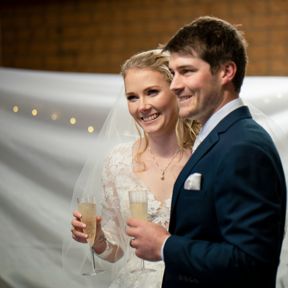 Bride and groom toasting at wedding reception in Canberra