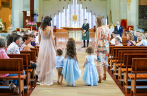 Flowers girls walking down aisle at Traditional church wedding in Fremantle