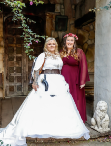 Bride posing with maid of honour at viking themed wedding