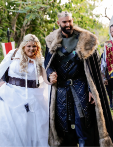second image of bride and groom walking down aisle at viking wedding