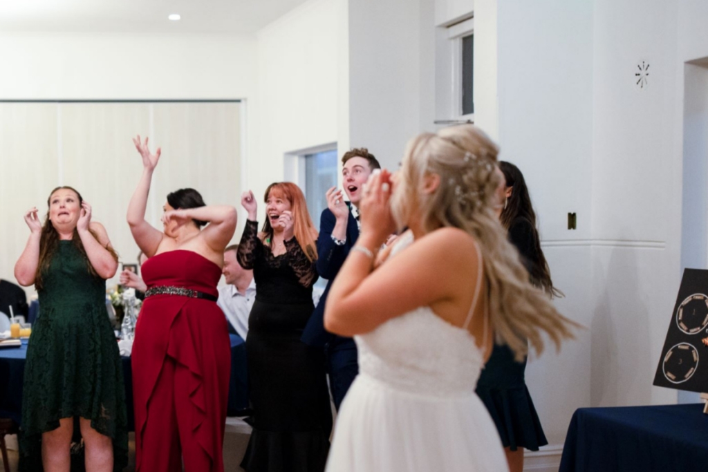 bouquet toss at wedding reception in Sydney captured by wedding photographer