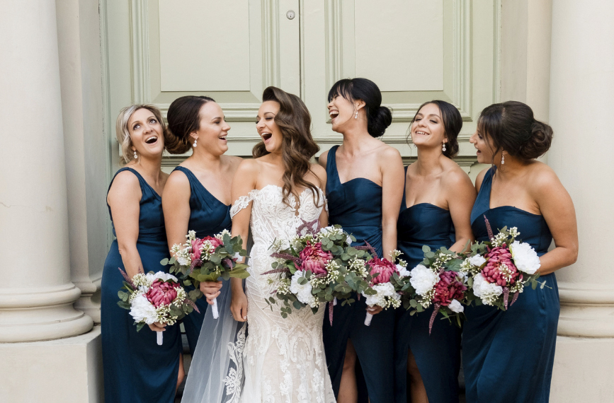Bride and bridesmaids posing for wedding photographer in Fremantle, Western Australia