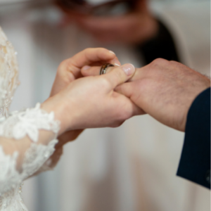 bride giving groom wedding ring