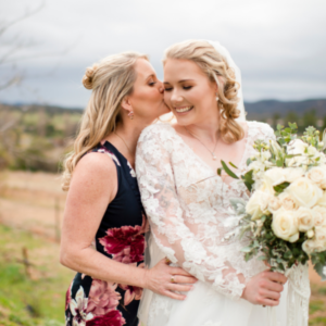 mother of the bride kissing bride