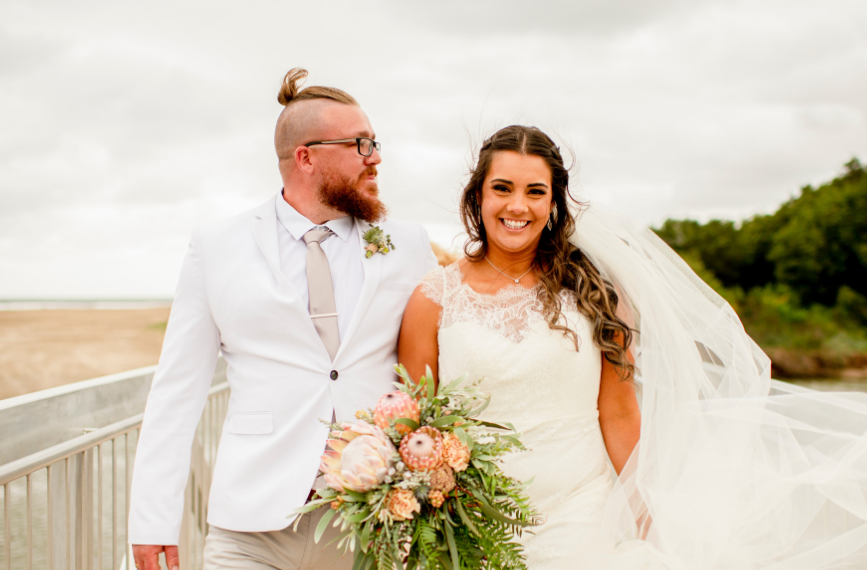wind blowing brides veil at beach wedding in NSW