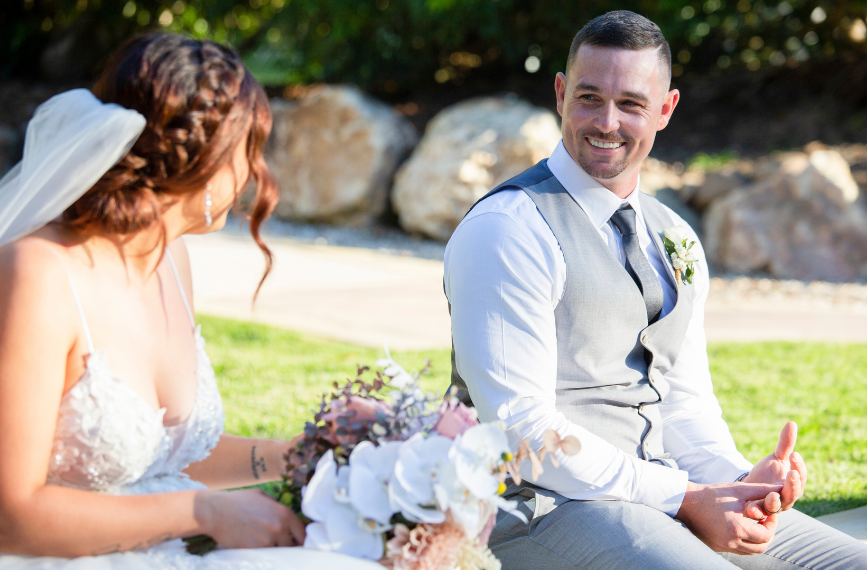 groom smiling at bride captured by wedding photographer