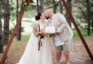 Bride and groom kissing at Pine Grove Centennial Park wedding ceremony