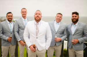 1 groomsmen holding beers at New South Wales beach wedding