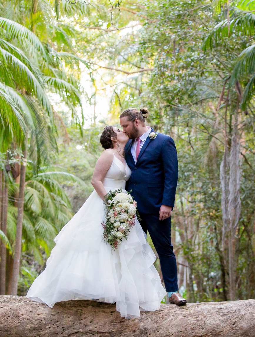 1 Bride and groom kissing over cedar creek