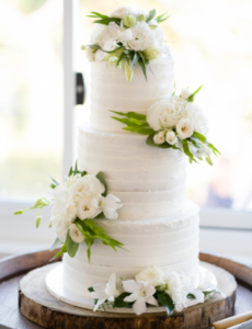 white tiered wedding cake with flowers