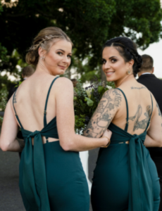 1 Bridesmaids in green dresses turning toward photographer