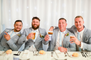 1 groomsmen holding beers