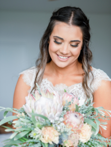 1 Bride looking at bouquet