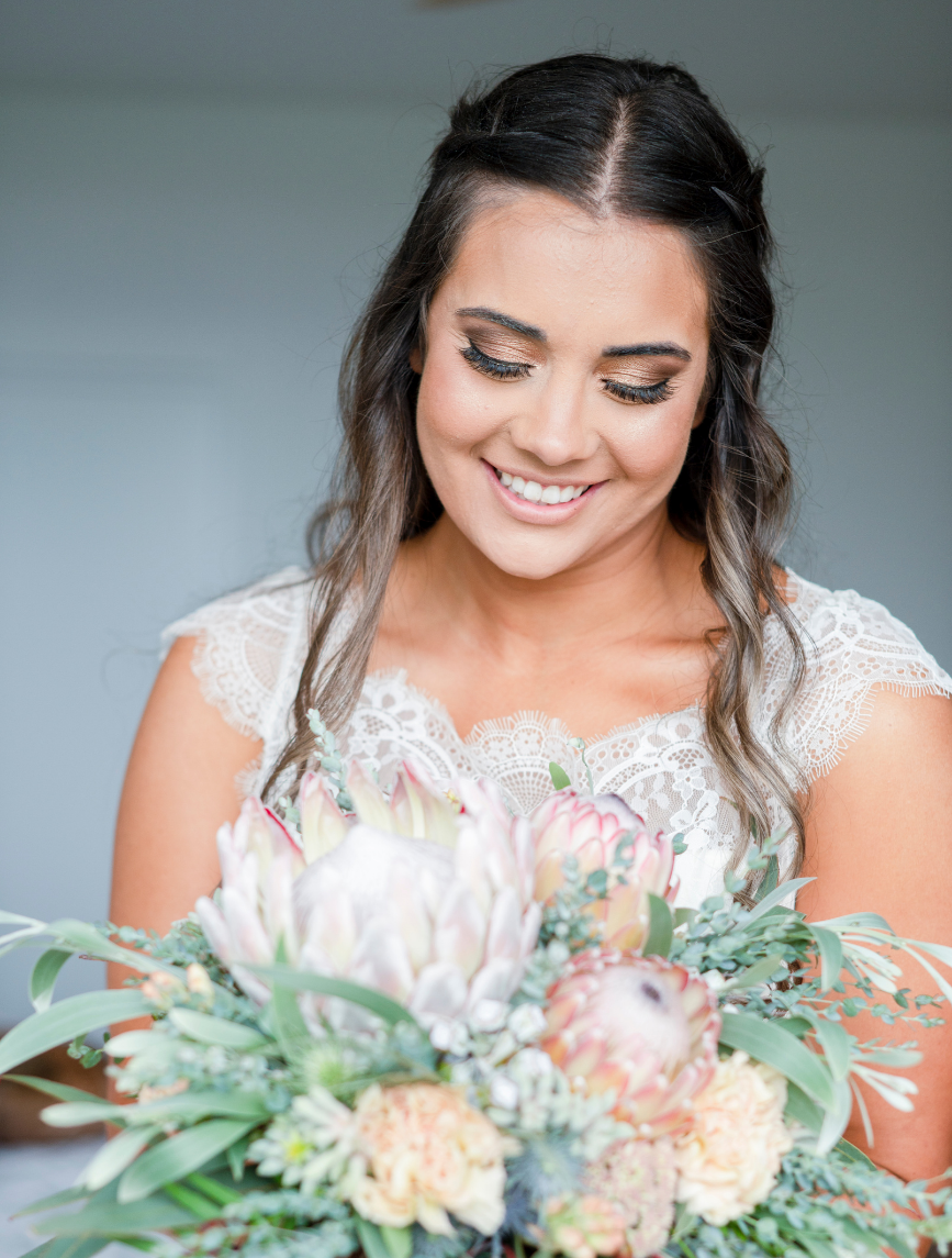 1 Bride looking at bouquet