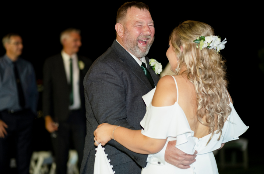 Father laughing during father daughter dance at Wollongong wedding