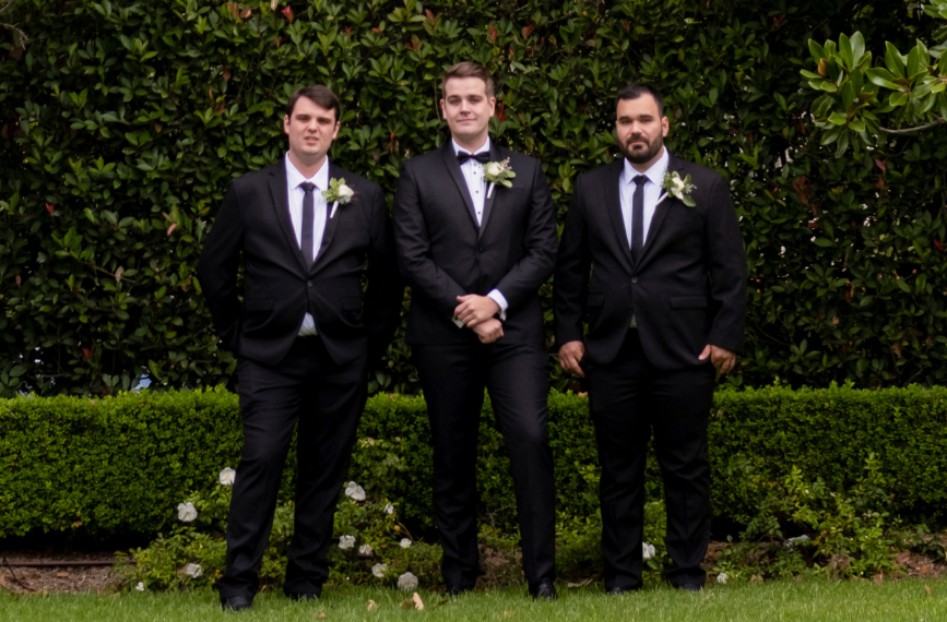 1 Groom and groomsmen in front of hedge at Cropley House