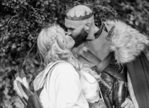 viking themed wedding photo of bride and groom kissing