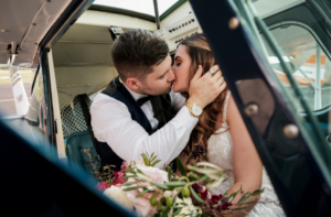 1 bride and groom kissing in plane at Camden Airport after wedding