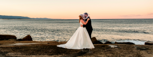 bride and groom kissing at veil at sunset in Wollongong