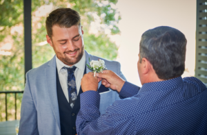 1 photo of groom getting ready with father before wedding