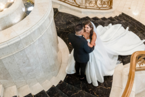 Bride and groom posing for wedding photographer on stairs at Sheldon Reception in Melbourne