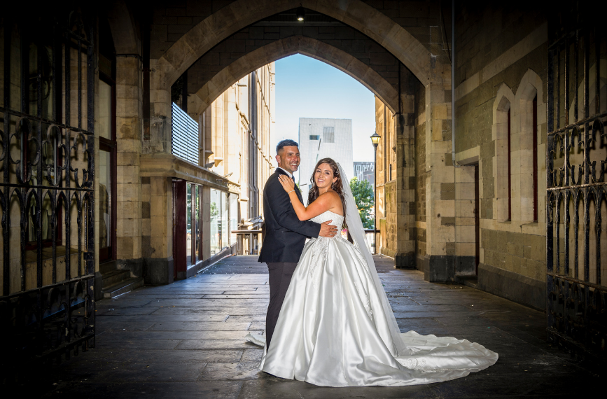 bride and groom posing for wedding photographer in Melbourne city