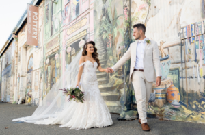 bride and groom walking through fremantle after wedding