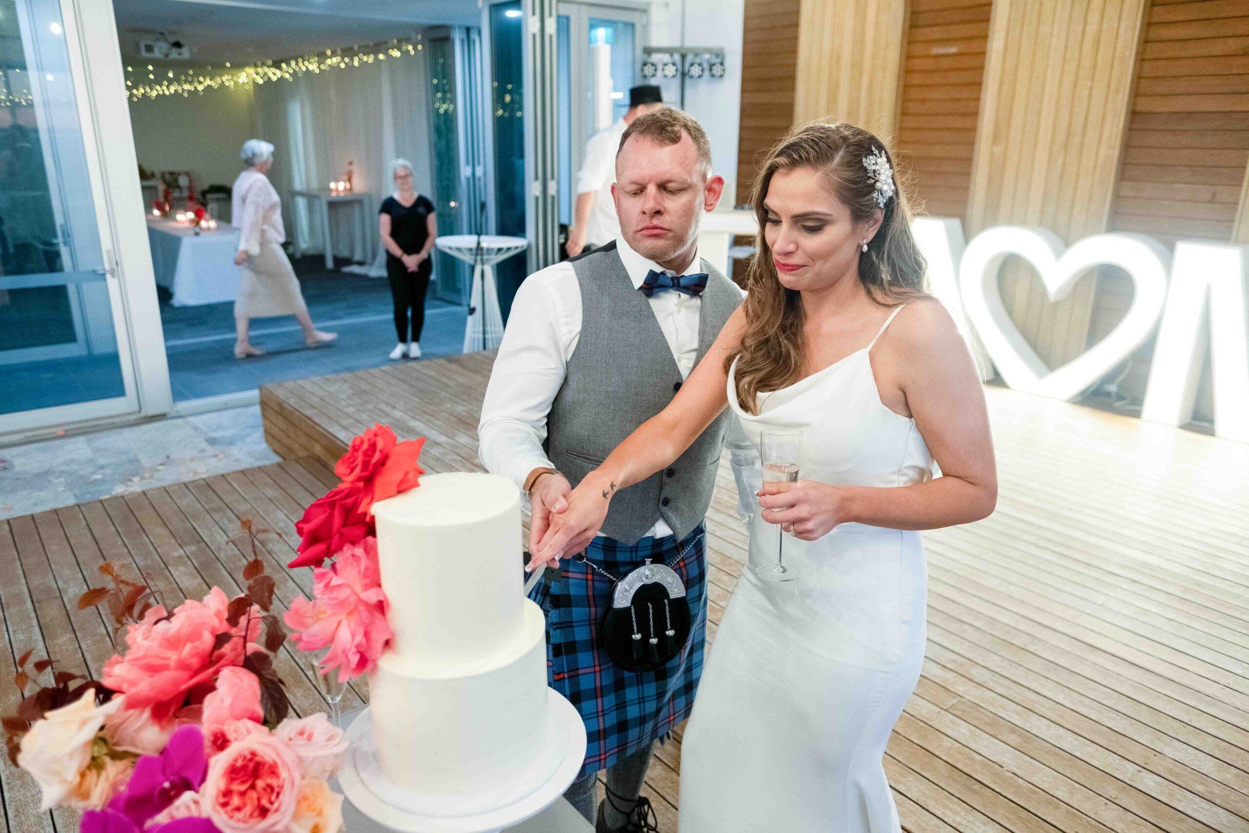 couple cutting cake at Perth wedding