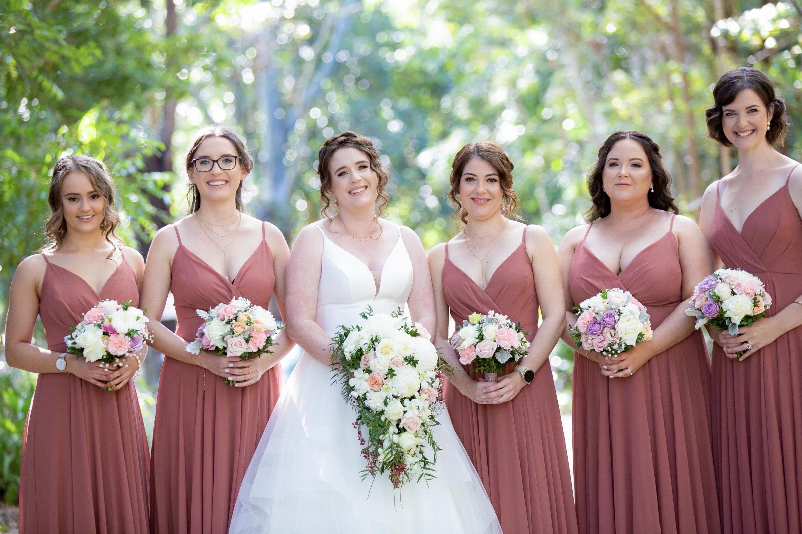 bride and bridesmaids posing for photographer at Brisbane wedding