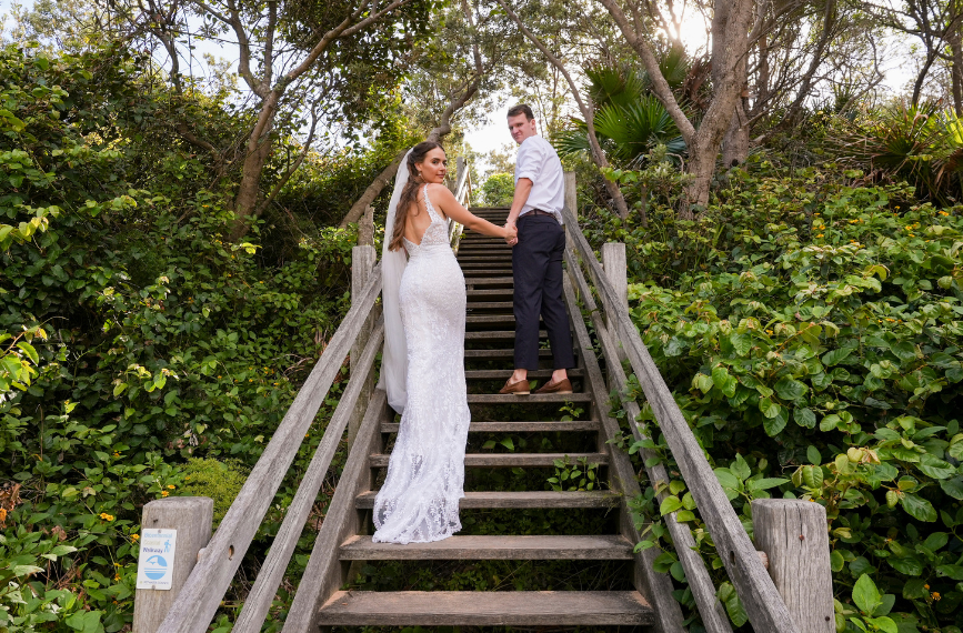 couple walking up stairs after Bigola wedding
